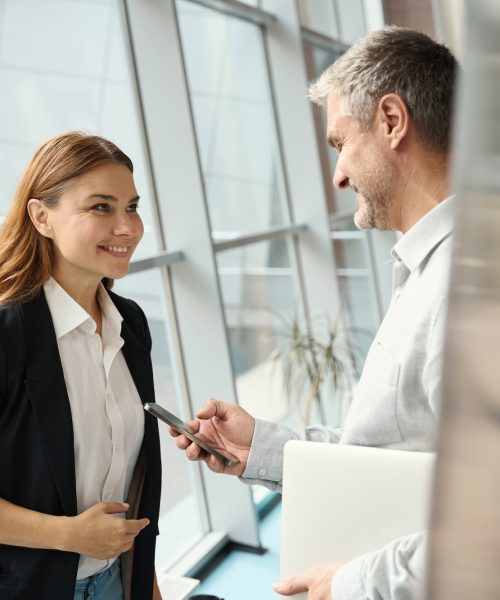 Employees of a financial company communicate at the window