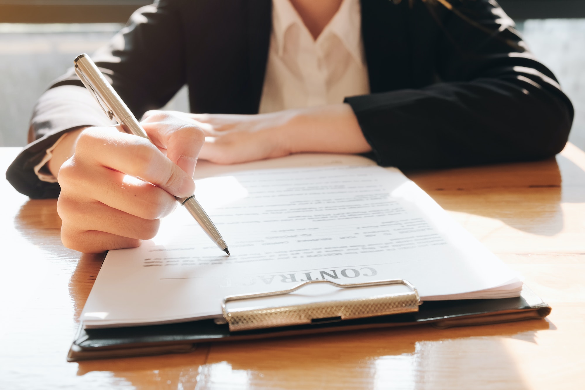 Close up business man signing contract making a deal with business partner - Business deal concept