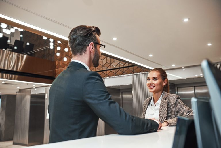 Couple on a business trip doing check-in at the hotel