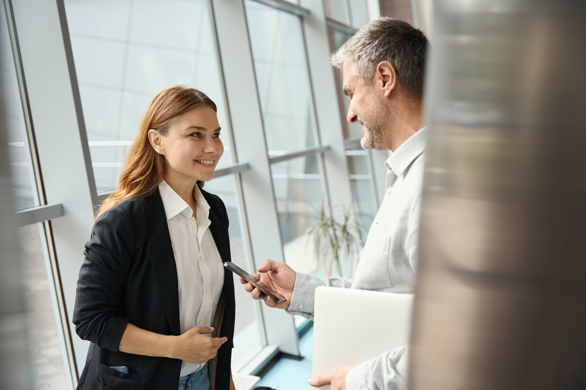 Employees of a financial company communicate at the window