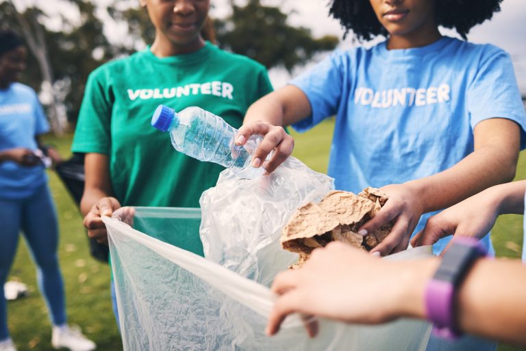 Recycle, plastic bag and ngo volunteer group cleaning outdoor park for sustainability. Nonprofit, r